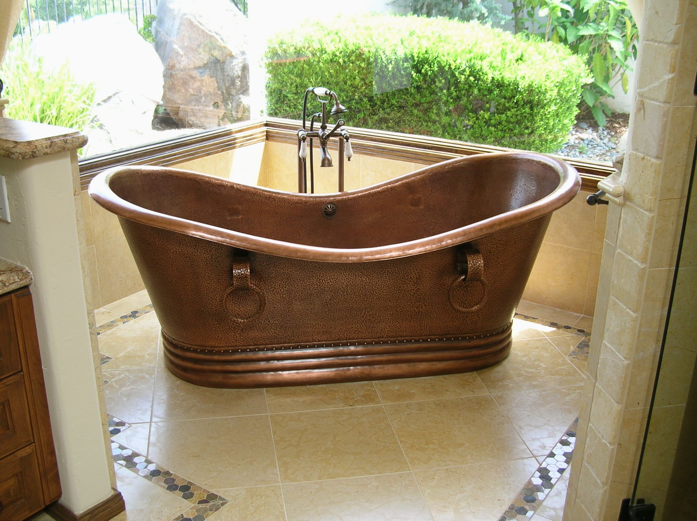 master_bathroom_design_with_copper_sipper_tub_limestone_floor_tiles_with_inset_mosaic_tile_border_3